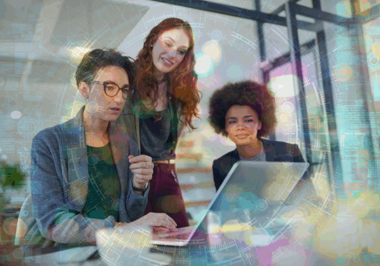 Three business women looking at a computer