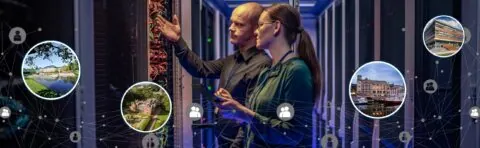 network engineers in a server room examining IT equipment