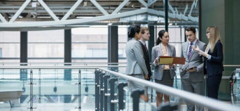 Business people meeting in the atrium of a smart building