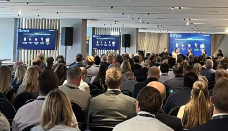 A crowded auditorium watching a panel discussion at this year’s REVO Conference in London.