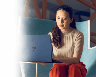  Woman works on a HP laptop computer in an office environment
