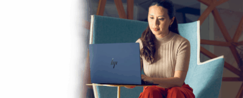  Woman works on a HP laptop computer in an office environment